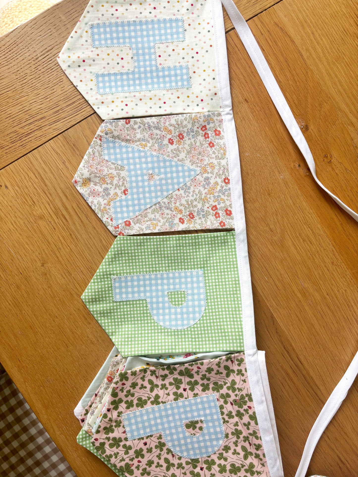 HAPPY BIRTHDAY BANNER - ASSORTED FLAGS W/ BLUE GINGHAM LETTERS